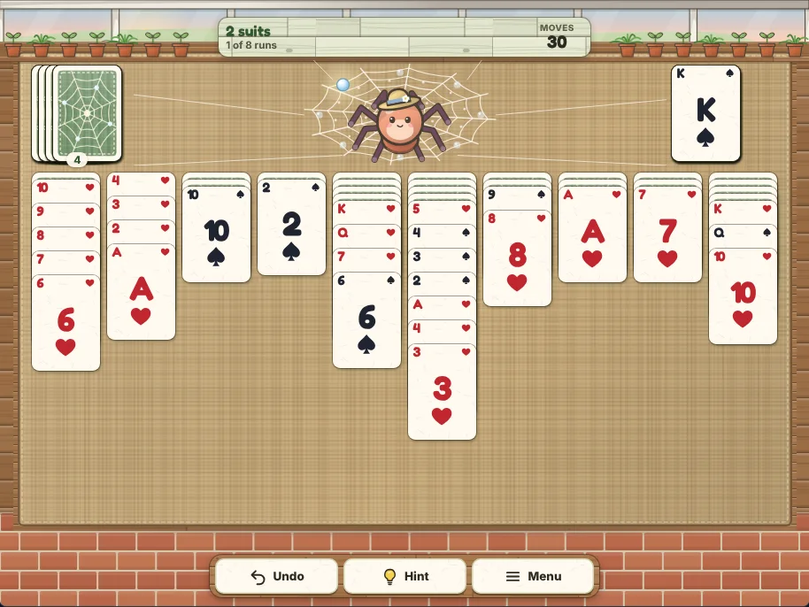Actual Dewdrop Garden Solitaire gameplay in a desktop browser: a two-suit deal 30 moves in, with one finished run of spades on the right of the potting bench, four deals left in the stock on the left and Thimble the garden spider in her web between them. Ten columns of spades and hearts lie on the burlap below, the first holding a run of hearts from the 10 down to the 6, with Undo, Hint and Menu on the brick sill at the bottom.