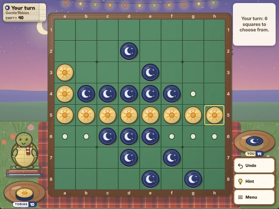 Actual Starling Hill Reversi gameplay on a desktop browser: the green felt board in the middle of a tartan blanket on a hilltop at dusk, indigo moon discs and cream sun discs partway through a game, cream dots on the squares you can play, Tobias the tortoise on his books at the left under the turn sign with his coaster and disc count, your coaster and count at the right, and Undo, Hint and Menu below them.