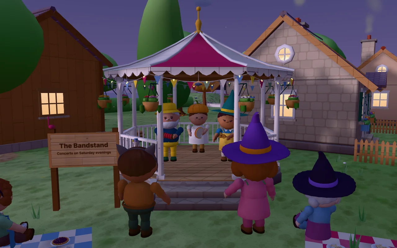 Actual CozyWorld Village screenshot: the band playing under the string lights of the bandstand after dark, with residents in Halloween costumes dancing and watching on the green.